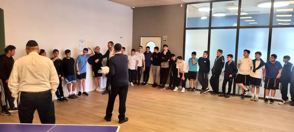 שורת תלמידים עומדת סביב חלל פעילות - יום אנגלית ברמת אקדמי